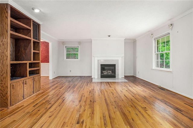 5247 Yeager Rd, Douglasville, GA 30135 - unfurnished living room featuring plenty of natural light, light wood finished floors, ornamental molding, a tile fireplace, and baseboards