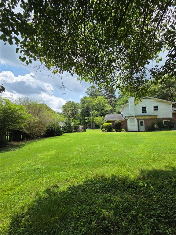 3400 Elm Creek Dr NW, Marietta, GA 30064 - view of grassy yard with a storage unit
