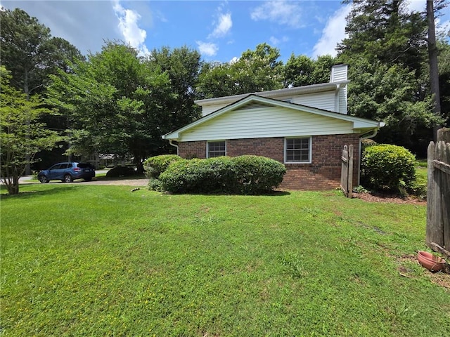 3400 Elm Creek Dr NW, Marietta, GA 30064 - view of side of home featuring a chimney, brick siding, and a lawn