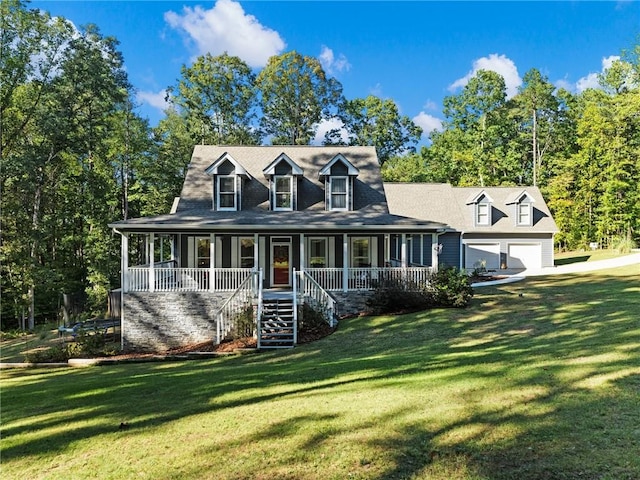 view of front of property with covered porch, a front yard, and a garage