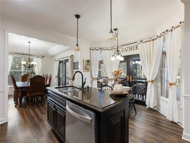 kitchen with dark stone counters, dark hardwood / wood-style floors, sink, a center island with sink, and stainless steel dishwasher