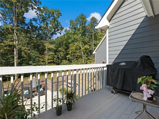 wooden deck featuring a grill