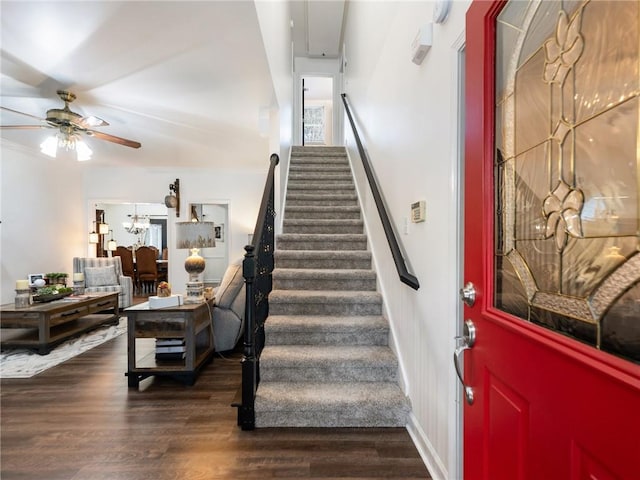 entryway featuring ceiling fan with notable chandelier and dark hardwood / wood-style floors