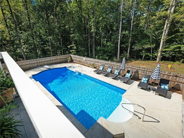 view of pool featuring a diving board and a patio area