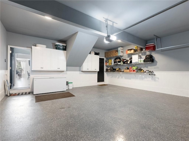 garage with a garage door opener and fridge