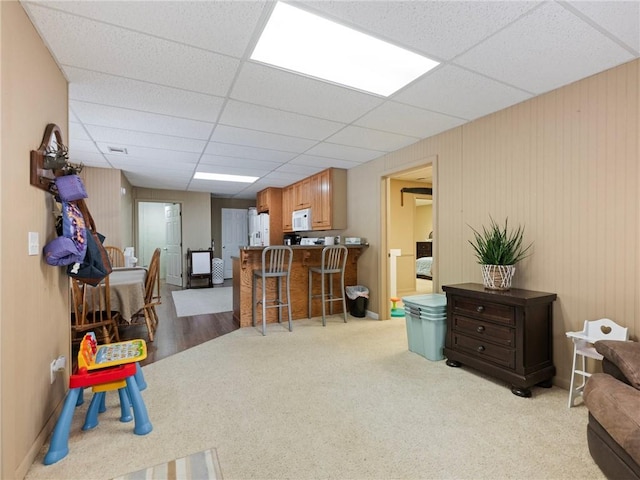 recreation room featuring light hardwood / wood-style floors and a drop ceiling