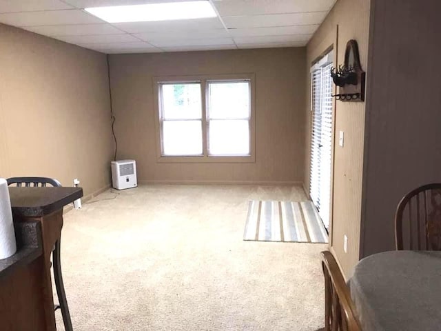 bedroom with a drop ceiling and carpet floors