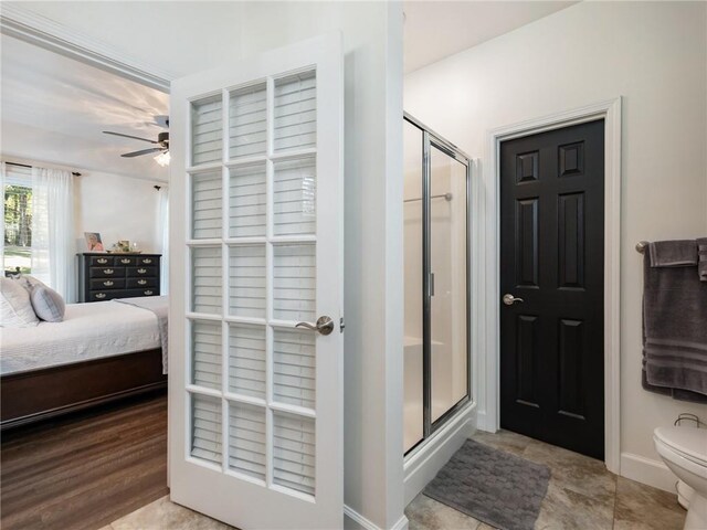 bathroom with wood-type flooring, toilet, an enclosed shower, and ceiling fan