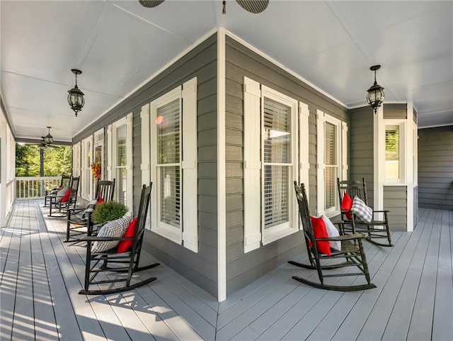 wooden deck featuring ceiling fan and covered porch