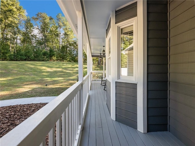 wooden deck with a yard and a porch