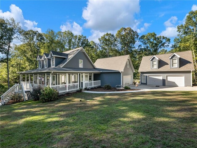 view of front of property featuring a porch, a garage, and a front yard