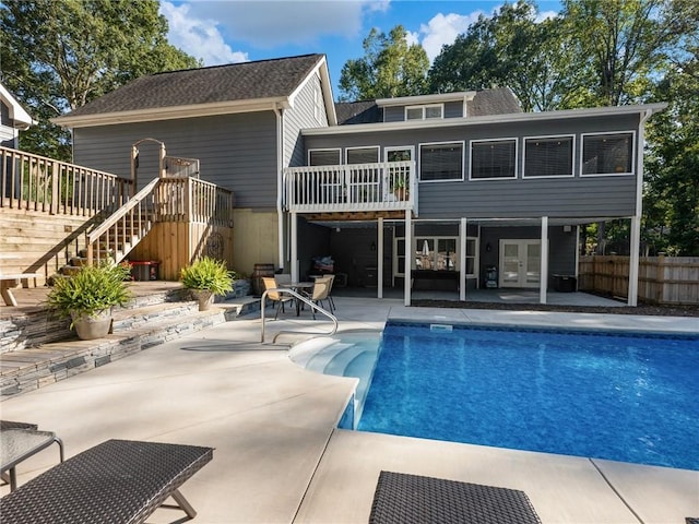 back of property featuring a pool side deck and a patio area