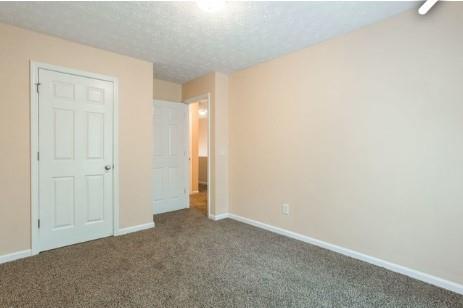 unfurnished bedroom with carpet