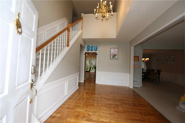 entrance foyer with hardwood / wood-style flooring and a chandelier