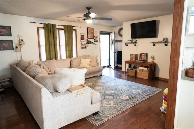 living room featuring dark hardwood / wood-style floors and ceiling fan