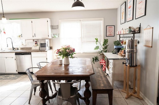 dining space with light tile patterned flooring and sink