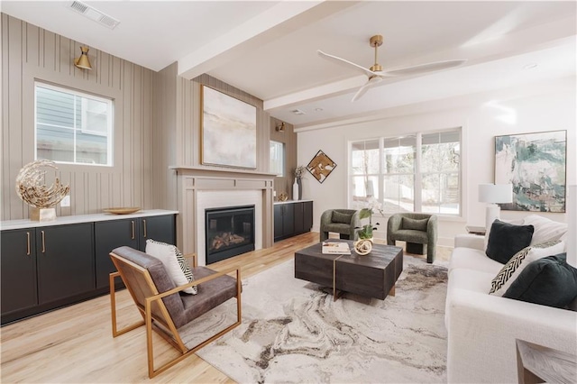 living room featuring light hardwood / wood-style flooring and ceiling fan