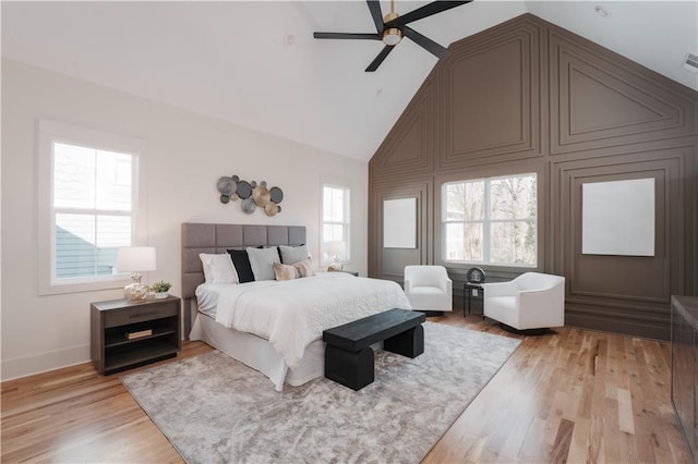 bedroom featuring high vaulted ceiling, ceiling fan, and light wood-type flooring