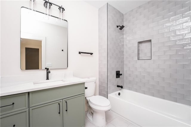 full bathroom with tile patterned floors, vanity, toilet, and tiled shower / bath combo