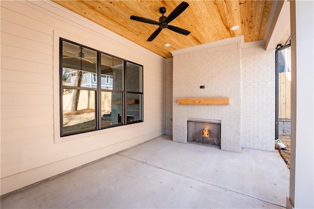 view of patio / terrace with ceiling fan and exterior fireplace