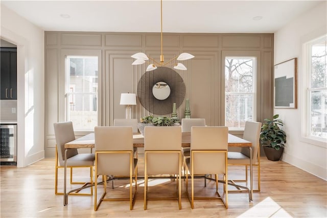 dining room with wine cooler and light hardwood / wood-style flooring