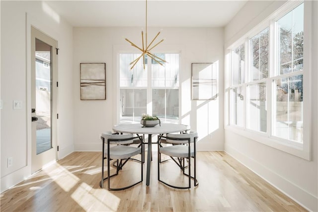 dining area with an inviting chandelier and light wood-type flooring