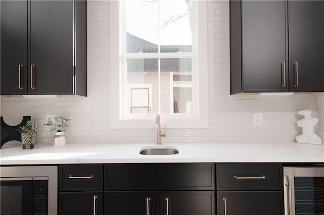 bar with wine cooler, sink, and backsplash