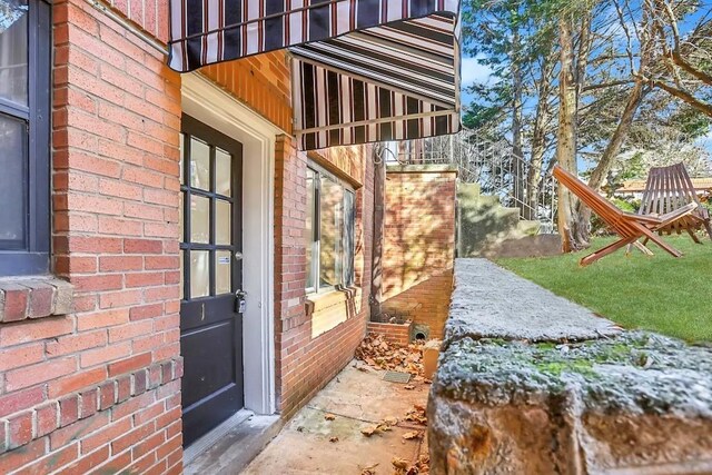 doorway to property featuring brick siding