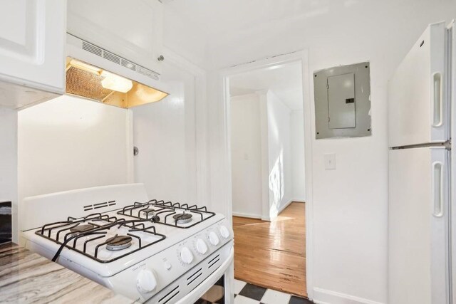 kitchen featuring ventilation hood, white appliances, and electric panel