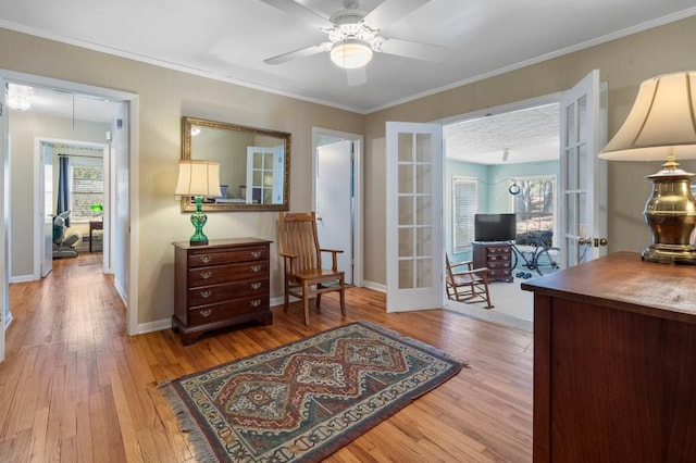 office with french doors, ceiling fan, crown molding, and light hardwood / wood-style flooring