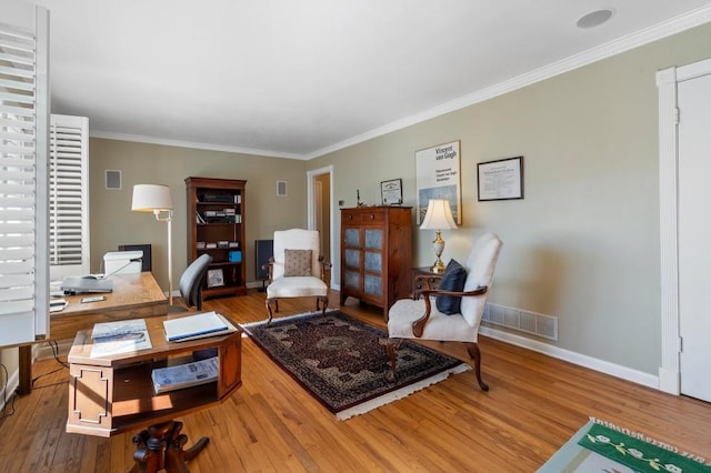 living area featuring ornamental molding and wood-type flooring