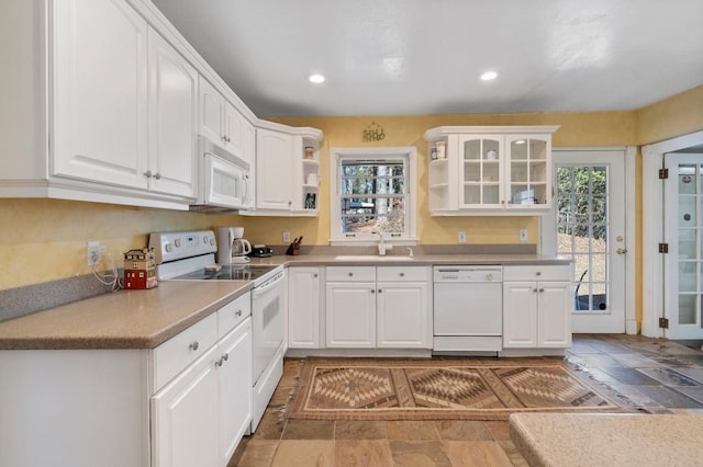 kitchen with sink, white cabinets, and white appliances