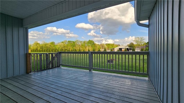 wooden deck with a lawn