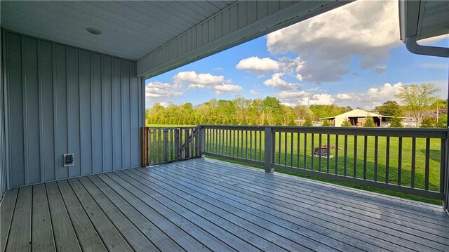 wooden deck featuring a yard