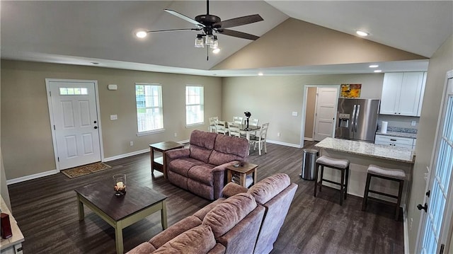 living area featuring baseboards, recessed lighting, a ceiling fan, dark wood finished floors, and high vaulted ceiling