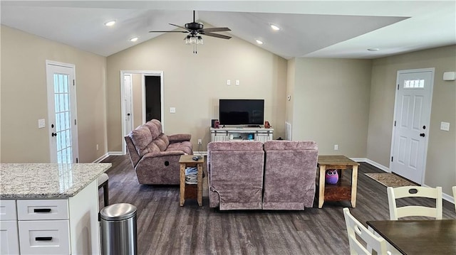 living area with dark wood-type flooring, ceiling fan, baseboards, and vaulted ceiling