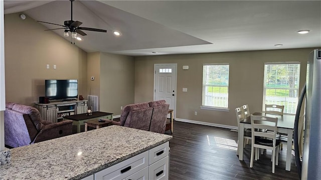 kitchen with white cabinetry, open floor plan, freestanding refrigerator, and a ceiling fan