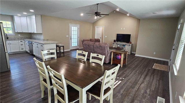 dining space with dark wood-type flooring, baseboards, vaulted ceiling, and ceiling fan