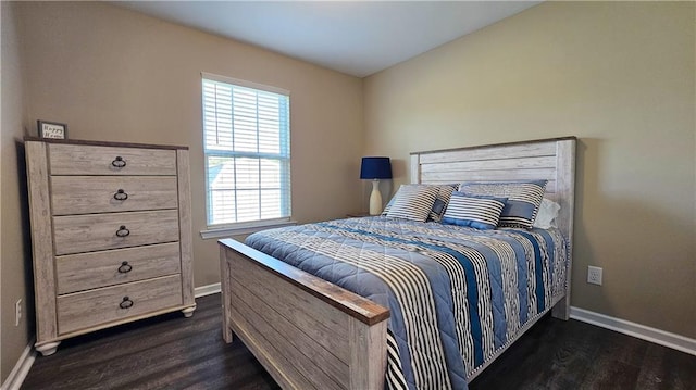 bedroom featuring baseboards and dark wood finished floors