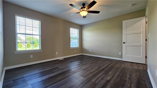 empty room featuring ceiling fan, baseboards, and dark wood-style floors
