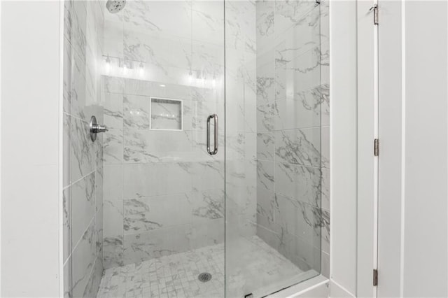 bathroom featuring a shower with shower door