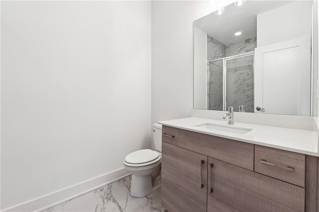 bathroom with vanity, a shower with shower door, and toilet