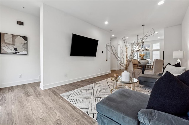 living room featuring a notable chandelier and hardwood / wood-style flooring