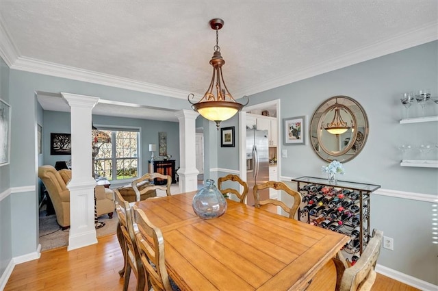 dining space featuring light hardwood / wood-style floors and ornamental molding