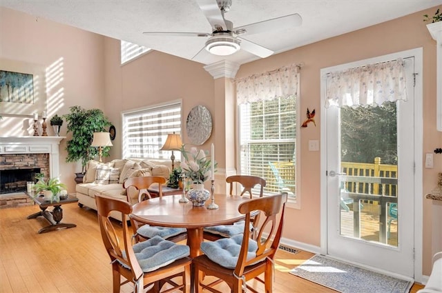 dining room featuring ceiling fan, a healthy amount of sunlight, and light wood-type flooring