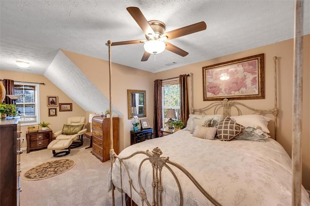 bedroom with carpet, ceiling fan, lofted ceiling, and a textured ceiling