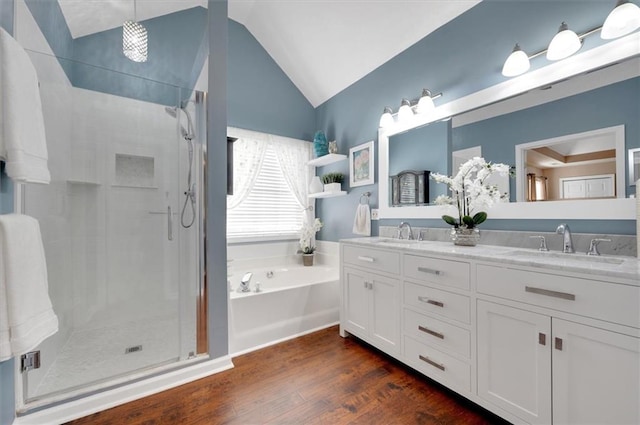 bathroom with wood-type flooring, vanity, shower with separate bathtub, and vaulted ceiling