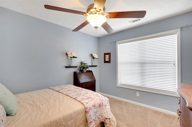 bedroom featuring light colored carpet and ceiling fan