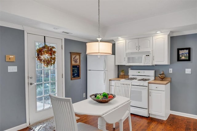 kitchen with dark hardwood / wood-style flooring, ornamental molding, white appliances, pendant lighting, and white cabinets