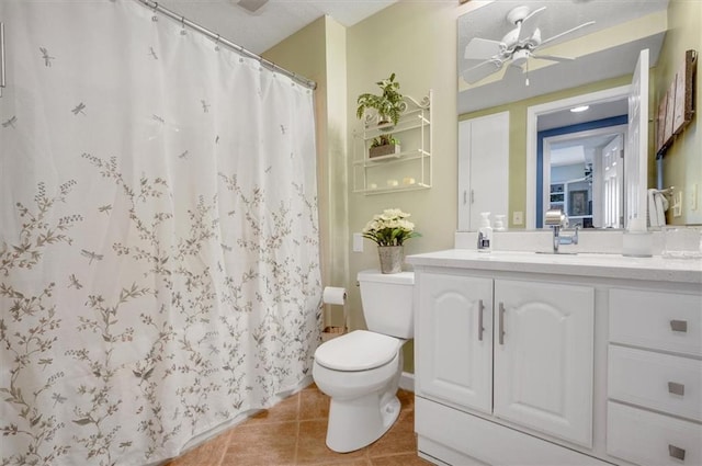 bathroom featuring ceiling fan, tile patterned flooring, toilet, vanity, and a shower with shower curtain